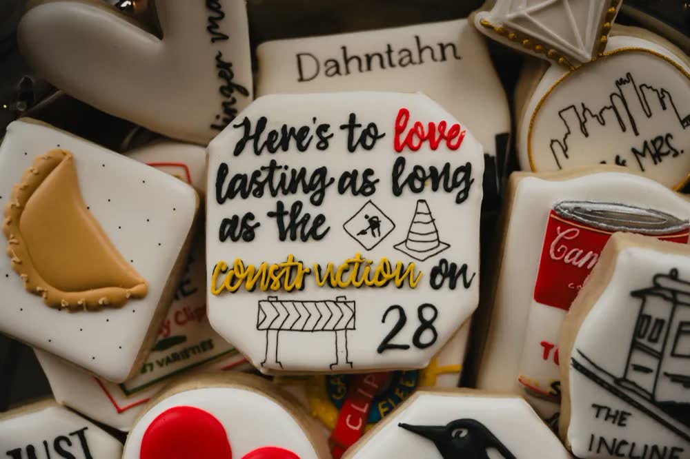 Decorated cookies including a pierogi and one reading 'Here's to love lasting as long as the construction on 28'