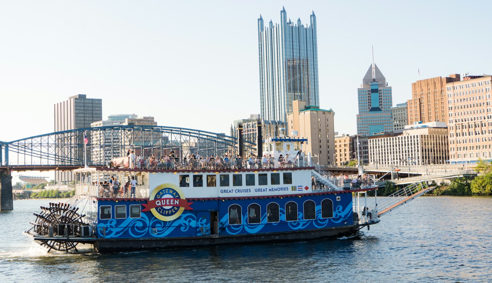 The Gateway Clipper Queen paddlewheeler cruising past downtown Pittsburgh and PPG Place with guests on the top deck