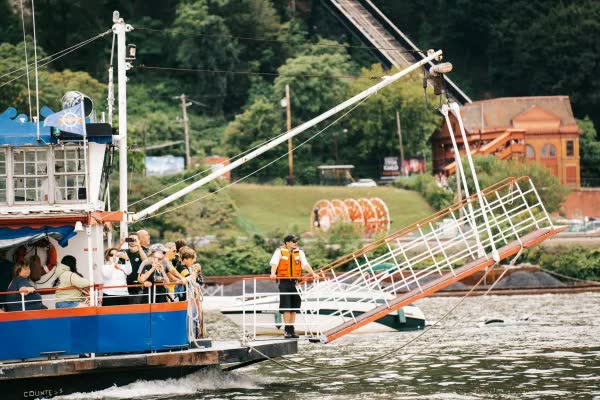 Guests aboard the Countess as a deckhand in a life vest stands by the gangway