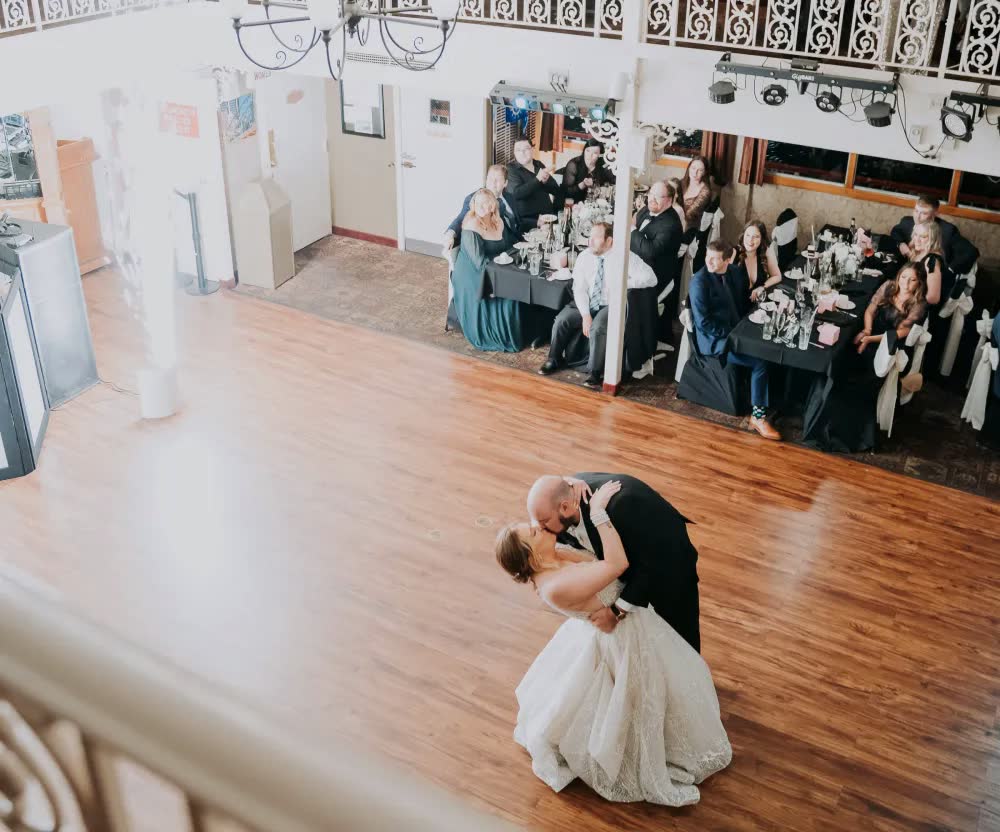 A first dance on the Princess's wooden dance floor, seen from the balcony as guests watch from their tables