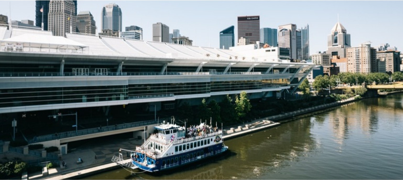 A Gateway Clipper riverboat passing downtown Pittsburgh