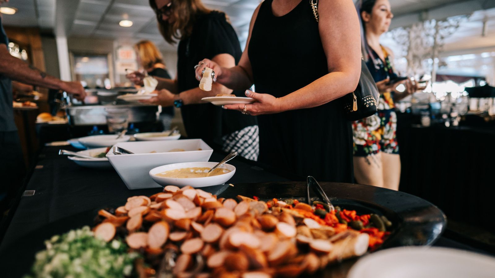 Guests helping themselves at a buffet aboard a Gateway Clipper riverboat
