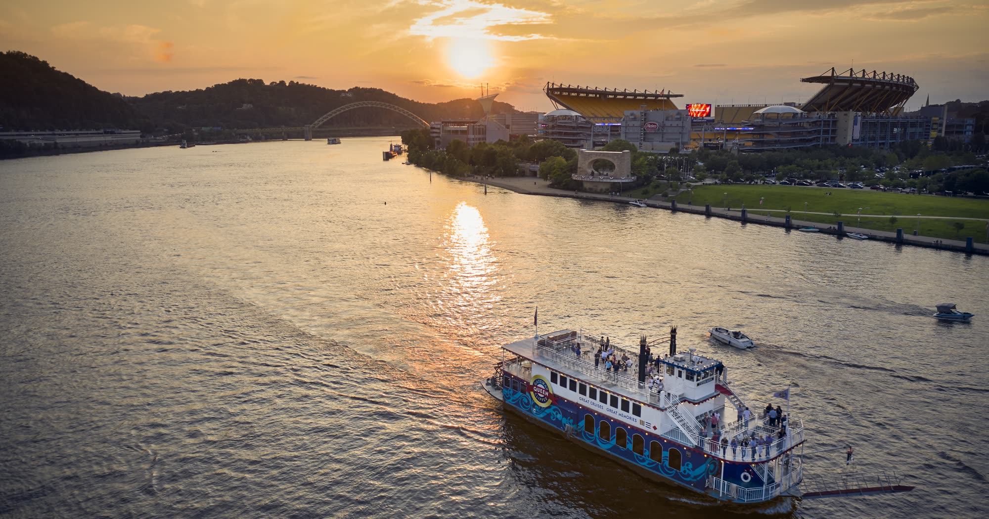 Aerial view of a Gateway Clipper riverboat on a Pittsburgh river at sunset