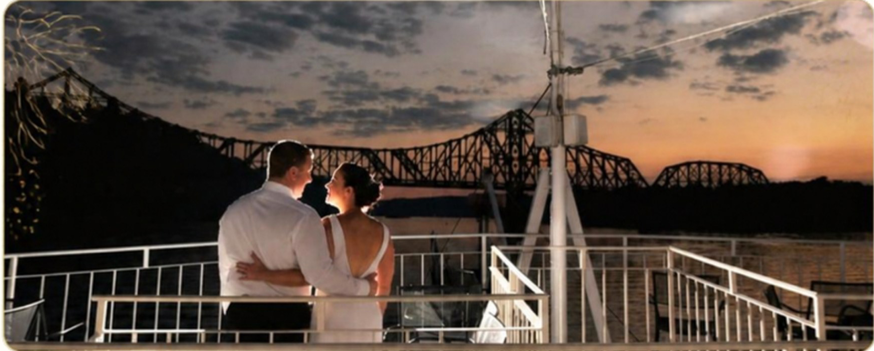 A couple on the rail of the top deck at golden hour