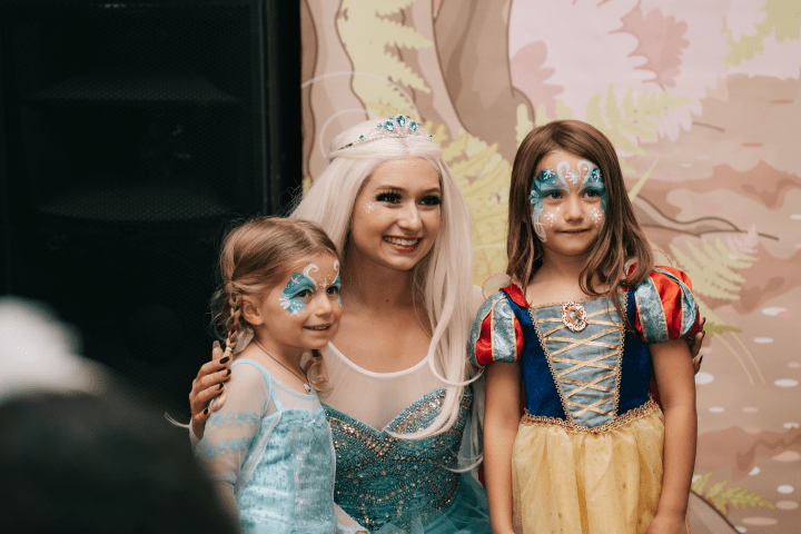 Three people dressed as princesses