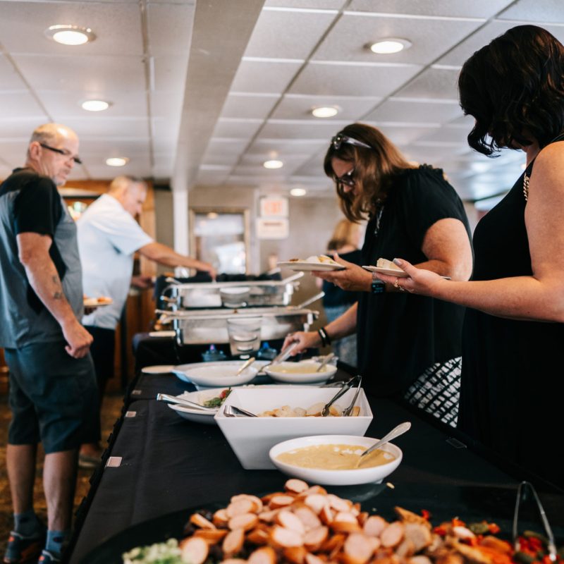 a group of people preparing food on a table