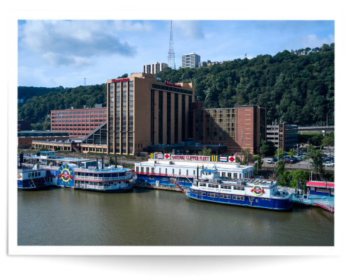 several large boats docked on a river