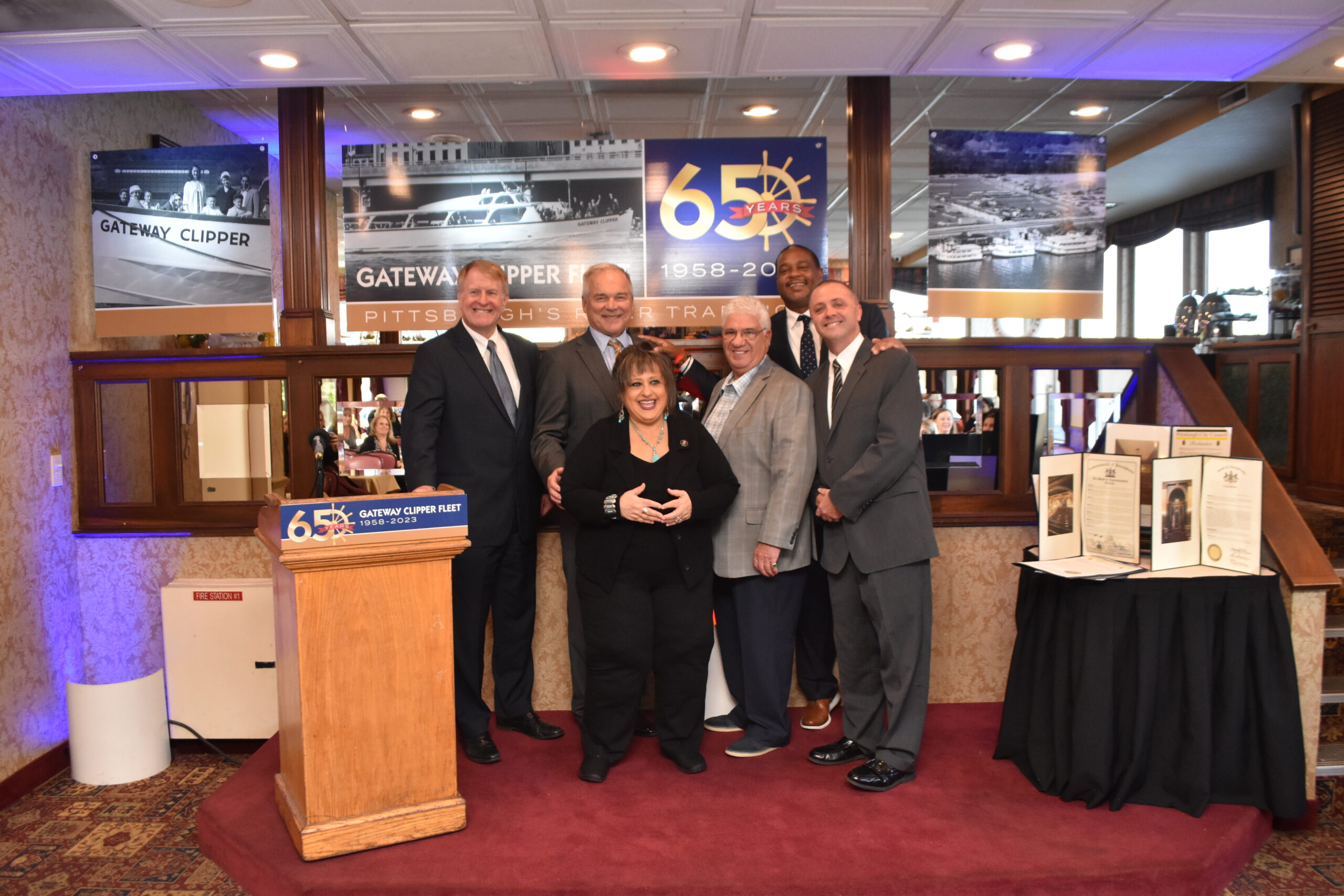 Rich Fitzgerald et al. standing in front of a store