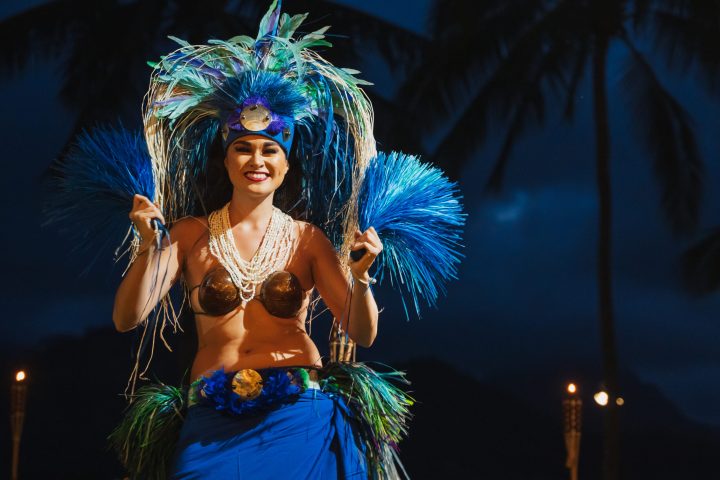 a person standing in front of a palm tree